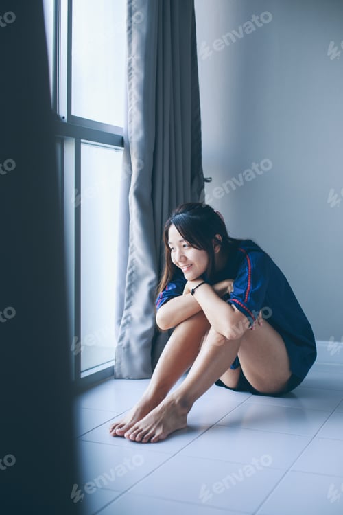 Preview: Pretty Asian Woman Sitting By The Window In The Morning.