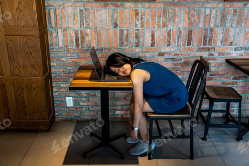 Preview: Young Exhausted Woman Fall Asleep On Her Laptop Keyboard