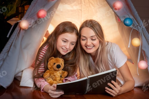 Preview: Happy Mother And Cute Daughter Reading Book Inside Tepee Tent Together In Bedroom, Family