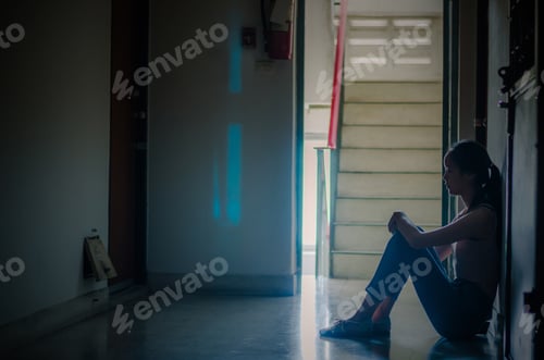 Preview: Silhouette Of Girl Sitting Alone,Sad And Serious Women Sitting Hug His Knee Alone Of Close Condo