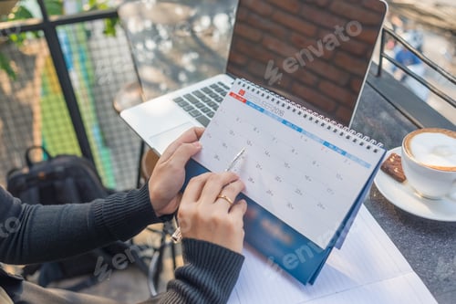 Preview: Young Woman Hand Carrying Calendar And Pointing On Meeting Day By Pen