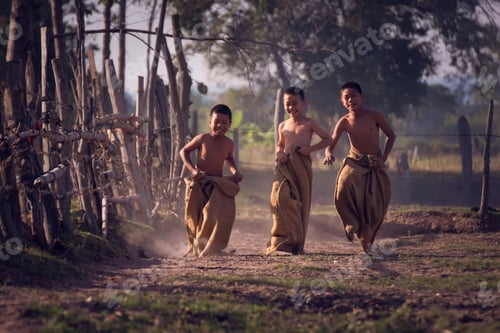 Preview: Lifestyle Boys In Countryside.Sack Race.Children Having A Sack Race On Countryside Of