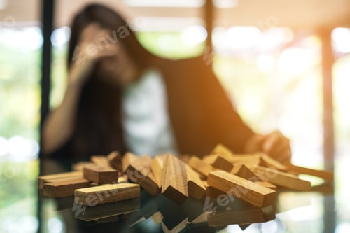 Preview: Businesswoman Get Stressed While Having A Problem At Work In Office With Wooden Blocks Of Tumble