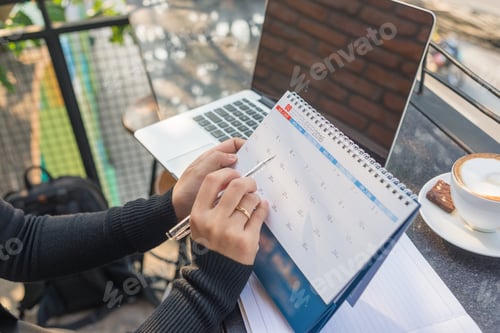 Preview: Young Woman Hand Carrying Calendar And Pointing On It By Pen
