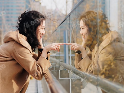 Preview: Beautiful Chinese Girl With Her Mirror Image In Glass. Outdoor Fashion Portrait Of Glamour Young