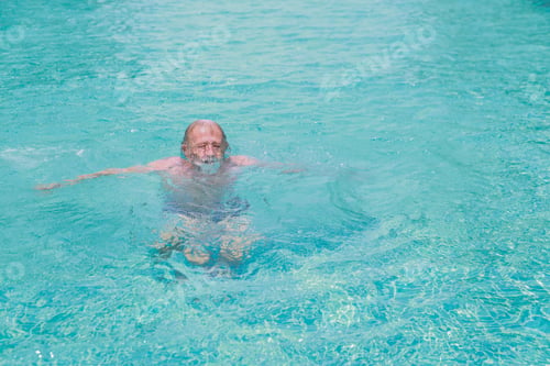 Preview: Happy Elderly Caucasian Swimming In Pool During Retirement Holiday After Awhile He Drowning Into