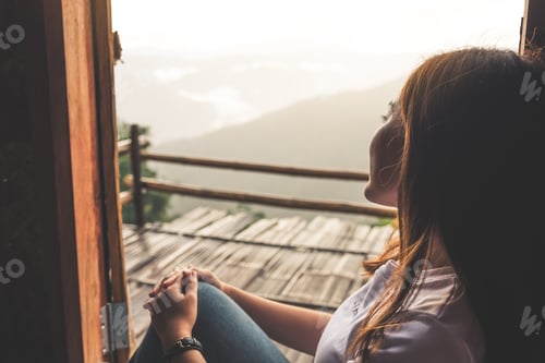 Preview: A Beautiful Asian Woman Sitting Alone And Looking At Mountains On Foggy Day With Blue Sky
