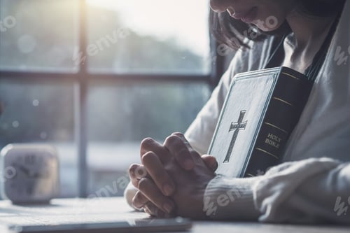 Preview: Christian Girl Holding Hands With Bible To Pray For Blessings From God By Faith.
