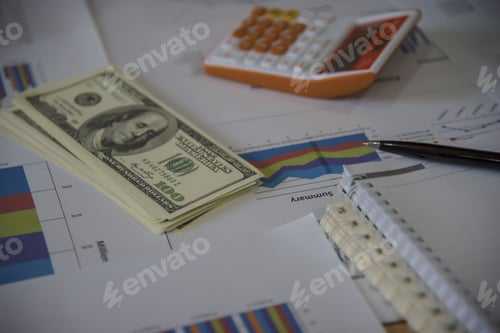 Preview: Financial Data and Currency on Workplace Desk