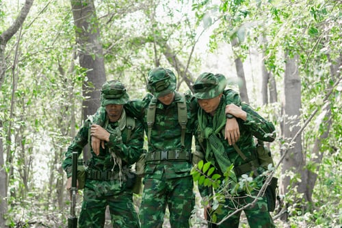 Preview: Soldier Carrying A Wounded Man From A Battle. The Military Is Responsible For Maintaining The