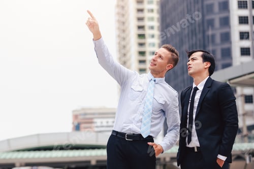 Preview: Two Business Men Standing Looking In City