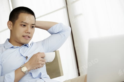 Preview: Handsome Businessman Man Using A Laptop Computer In The Coffee Shop.