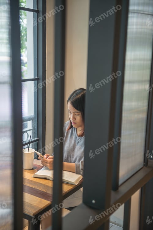 Preview: Asian Student Texting Message On Smart Phone