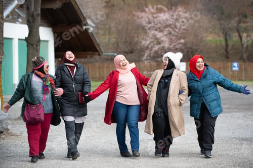 Preview: Group Of Muslim Friends Walking And Laughing Together. Winter Clothing.