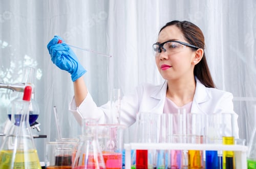 Preview: Scientist Beautiful Woman Research And Drop Medical Chemicals Sample In Test Tube At Laboratory