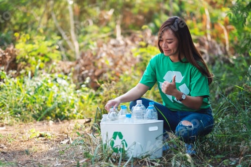 Preview: An Asian Woman Making Thumbs Up Hand Sign While Collecting Garbage Plastic Bottles Into A Recycle