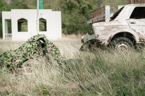 Preview: Sniper Soldier Lying On The Ground And Camouflage In Grass. Soldier Holding Gun Weapon And Waring