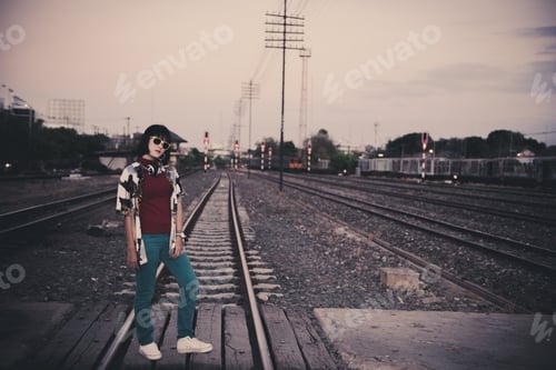 Preview: Portrait Of Asian Hipster Girl On Sunset At Railway Vintage Style,Grain And Noise Has Been Added To