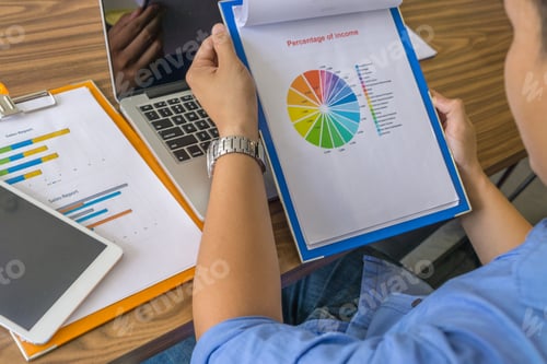 Preview: Young Office Man In The Blue Shirt Reading Report