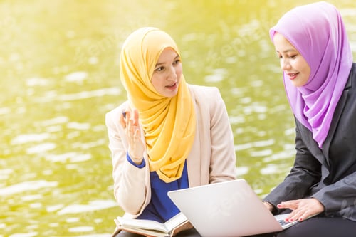 Preview: Muslim Businesswomen Having A Discussion With A Laptop By Lake