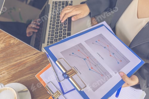 Preview: Top View Of Woman Holding Financial Document And Using Laptop