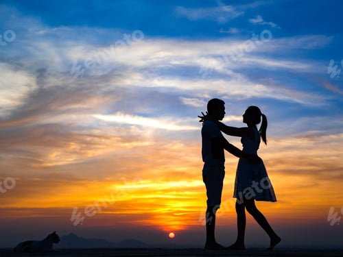 Preview: Silhouette Of Happy Young Couple Hugging Outside At Sunset, Talking