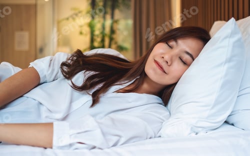 Preview: A Beautiful Asian Woman Sleeping In A White Cozy Bed At Home