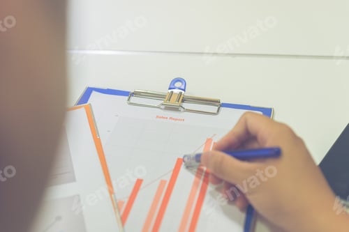 Preview: Young Businessman Holding Pen And Checking Finance Report