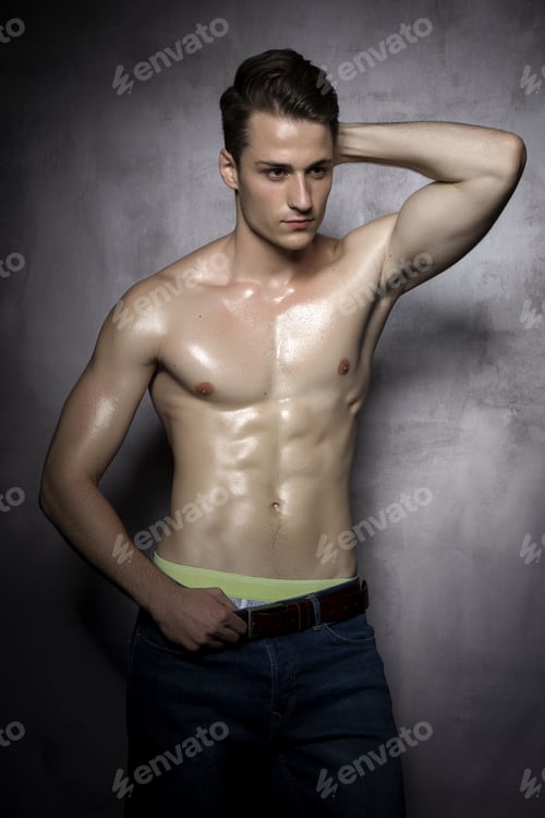 Preview: Sexy Shirtless Male Model Flirting Against Of Grunge Wall.