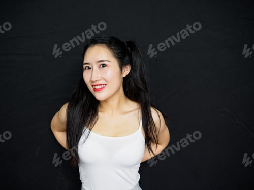 Preview: Portrait Of Good Looking Sexy Chinese Woman With Long Black Hair And White Halter Against Black