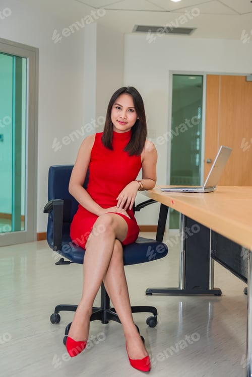 Preview: Business Girl In Red Dress Sit For Work On Laptop,Business Woman Work In Office Concept,Thailand