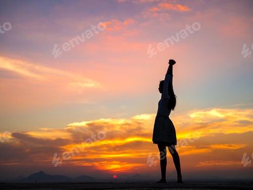 Preview: Silhouette Of Free Woman Enjoying Freedom Feeling Happy At Sunset. Relaxing Woman In Pure Happiness