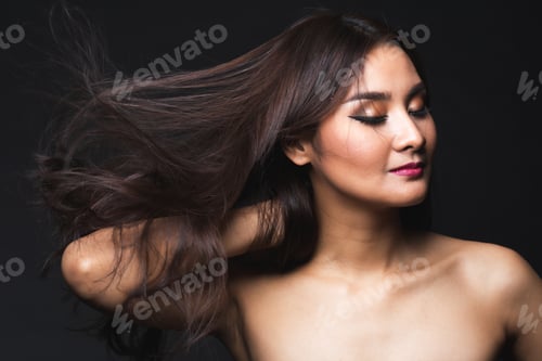 Preview: Portrait Of Young Asian Woman With Makeup Long Hair On The Black Isolated Posing.