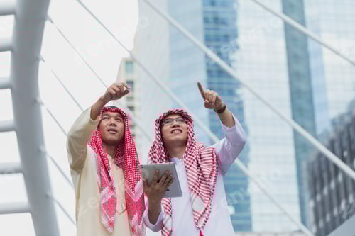 Preview: Two Arab Or Muslim Business Man Standing At Front Modern Office Discussing Work With Tablet. Ethnic