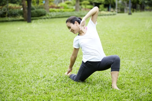 Preview: Attractive Healthy Asian Woman Doing Yoga In The Park