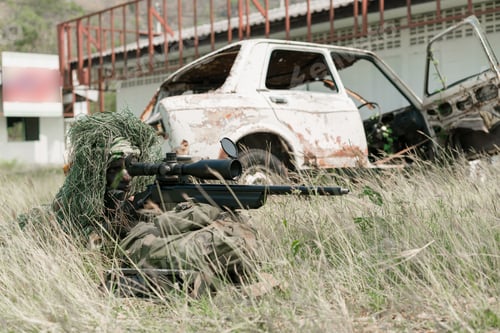 Preview: Sniper Soldier Lying On The Ground And Camouflage In Grass. Soldier Holding Gun Weapon And Waring