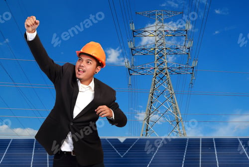 Preview: Engineer Man With Solar Panel Against High Voltage Towers Background.