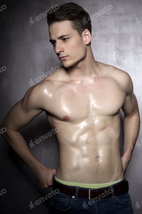 Preview: Sexy Shirtless Male Model Flirting Against Of Grunge Wall.