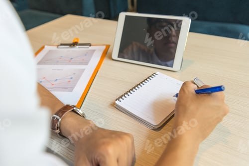 Preview: Rear View Of Man Writing Notes In The Office