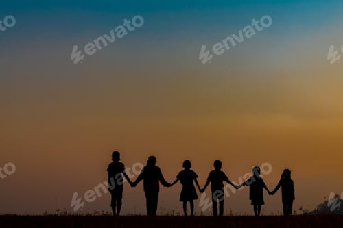 Preview: The Silhouette Of The Team Of Children Jumping Playing With Joy In The Mountains In The Setting Sun