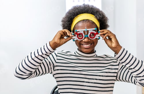 Preview: Smiling Young Woman African American Checking Vision With Eye Test Glasses During A Medical