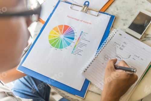 Preview: Rear View Of Man Reading Data And Writing Notes