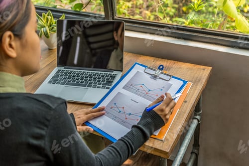 Preview: Woman Holding Sales Report Working In Garden View Office