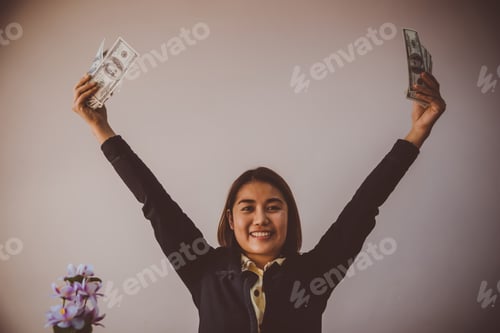 Preview: Businesswoman Displaying A Spread Of Cash Over A Green Vintage Background