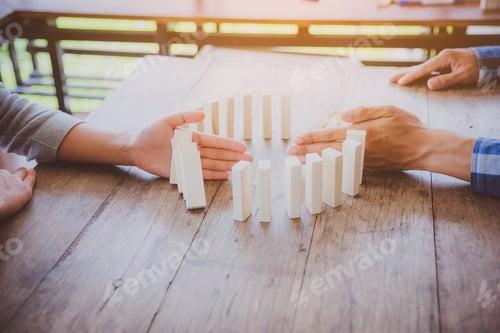 Preview: Businessmen Put A Hand On The Dominoes