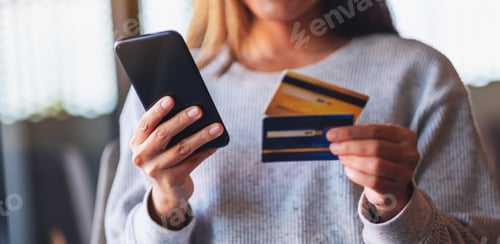 Preview: Woman Holds Phone and Credit Cards Indoors