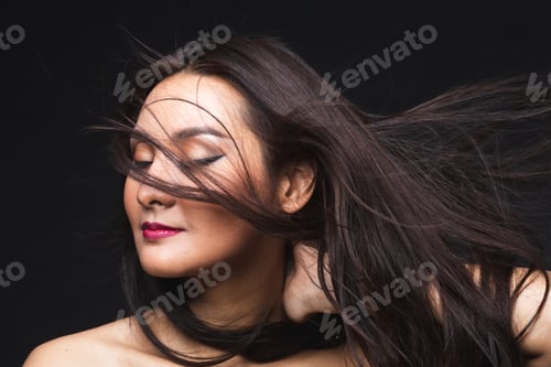 Preview: Portrait Of Young Asian Woman With Makeup Long Hair On The Black Isolated Posing.