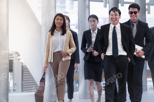 Preview: Group Of Asian Business People Walking And Smiling With Colleague On Business Street Background