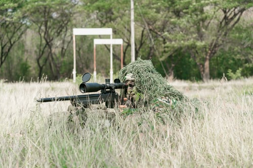 Preview: Sniper Soldier Lying On The Ground And Camouflage In Grass. Soldier Holding Gun Weapon And Waring