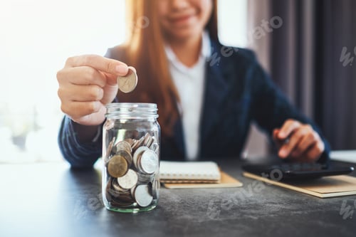 Preview: Woman Adds Coin to Jar For Financial Savings